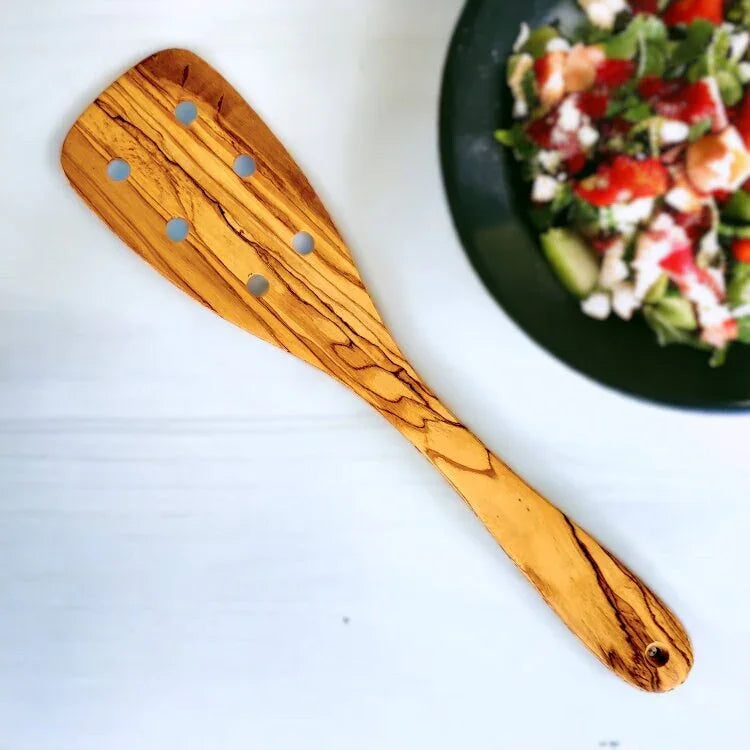 Olive wood spatula with holes – handcrafted and natural design